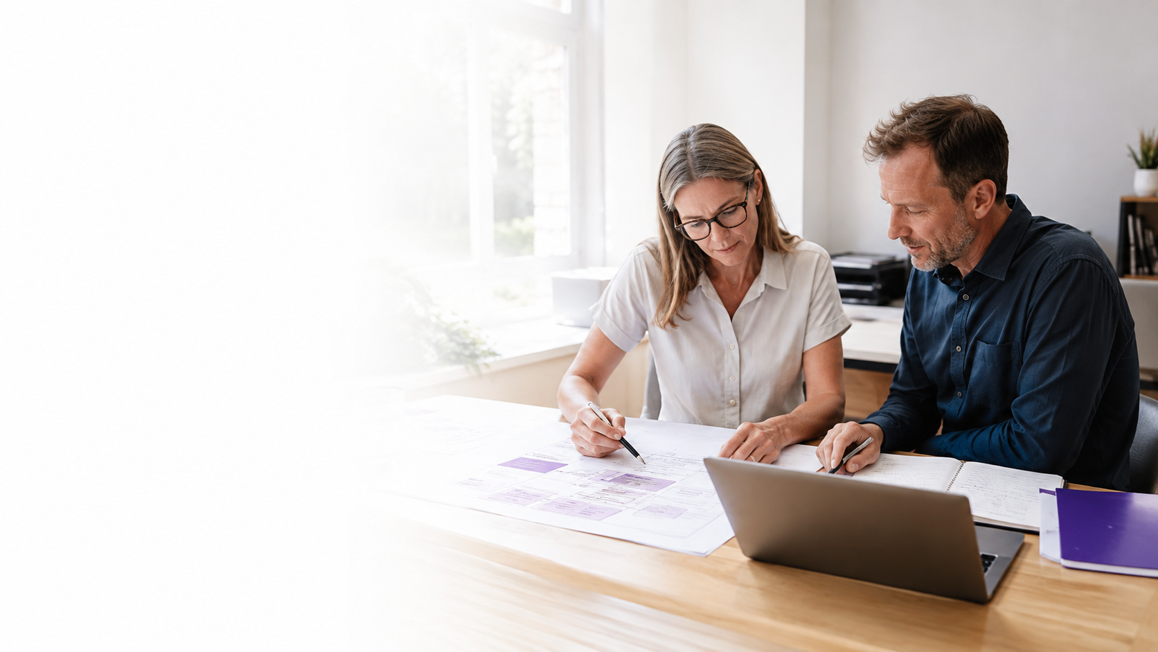 Two registry professionals reviewing a service blueprint together.